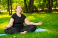 meditation in the park, a portrait of a focused model over size during a yoga