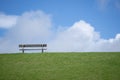 Meditation. Peace meadow. Lonely wooden bench. Peaceful and quiet place. Loneliness. Calm place. Rest and relax. Relaxation Royalty Free Stock Photo