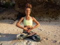 Meditation and pranayama. Caucasian woman sitting on the sand, practicing breathing techniques. Yoga on the beach. Healthy Royalty Free Stock Photo