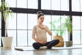 Meditation during pregnancy. Young calm tranquil pregnant woman doing yoga at home, meditating and practicing mindfulness, Royalty Free Stock Photo