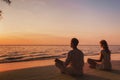 meditation and relaxation for couple, yoga group on the beach Royalty Free Stock Photo