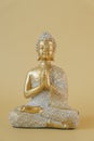 Meditation and relaxation symbol. Buddhism background.Buddha golden statue on beige background.Beautiful meditation and