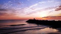 Meditation on the rocks, a man sitting on a rock in the sea at sunset