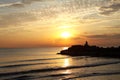 Meditation on the rocks, a man sitting on a rock in the sea at sunset