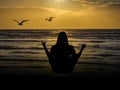 Meditation by the sea in the evening sun Royalty Free Stock Photo