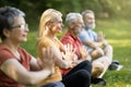 Meditation Session. Group Of Sporty Senior People Practicing Yoga Together In Park Royalty Free Stock Photo