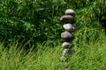 Meditation space in peaceful garden with river rock stack, serene green foliage