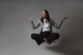 Meditation and stress control at work, a young woman in a business suit,