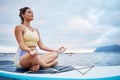 Meditation, surf and sea with a woman on a surfboard floating out in nature with a cloudscape and mockup. Yoga, ocean Royalty Free Stock Photo