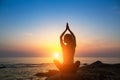 Meditation woman yoga silhouette on the Sea beach during amazing sunset. Royalty Free Stock Photo