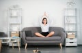 Meditation at work. Calm young business woman taking break doing yoga exercise at workplace, happy female secretary Royalty Free Stock Photo