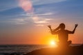 Meditation yoga woman silhouette, ocean during amazing sunset. Royalty Free Stock Photo