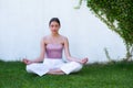 Meditation yoga woman in spring park. Woman stretching. Young girl practicing yoga, doing fit exercise, working out on Royalty Free Stock Photo