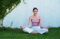 Meditation yoga woman in spring park. Woman stretching. Young girl practicing yoga, doing fit exercise, working out on Royalty Free Stock Photo