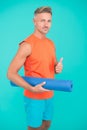 Meditations designed to help you find your joy. Man practicing yoga at home. Handsome sportsman with yoga mat. Workouts