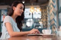 Meditative female freelancer working on laptop