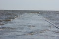 Meditative sea pier submerged by the waves at high tide