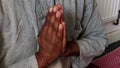 A meditator with hands clasped together in a prayer position