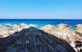 Mediteraneean blue sea beach umbrellas