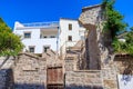 Mediterranean architecture with stone wall and white house and clear blue sky Royalty Free Stock Photo