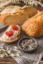 Mediterranean baguette with herbes and sel de mer, one slice with cream cheese and tomatoes