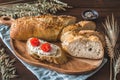 Mediterranean baguette with herbes and sel de mer, one slice with cream cheese and tomatoes