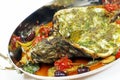 mediterranean baked sea bass fish with tomato, caper, artichoke, olive sauce
