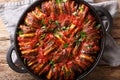 Mediterranean baked various vegetables in tomato sauce close-up in a pan. Horizontal top view