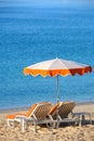 Mediterranean sea beach with chairs and sun umbrella vertical