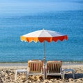 Mediterranean beach chairs sun umbrella sunbathing square blue sea background