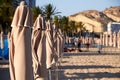 Mediterranean beach with some folded umbrellas