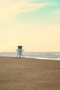 Mediterranean beach with vintage and lonely lifeguard wooden tower