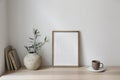 Mediterranean breakfast still life. Cup of coffee, books. Empty wooden picture frame mockup on desk, table. Textured Royalty Free Stock Photo