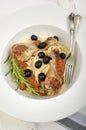 Mediterranean chicken drumsticks on spaghetti