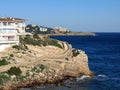 Mediterranean coast, rocks, stones, steep coast, white houses, blue sea. Beautiful seascape. Salou Royalty Free Stock Photo