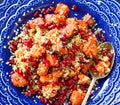 Mediterranean couscous salad with pomegranate seeds