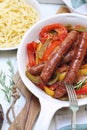 Mediterranean cuisine. Fried sausages stewed in bell pepper, onion and tomato sauce