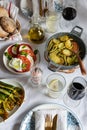 Mediterranean cuisine, served dinner, burrata cheese, olive oil, tomato, stuffed potato, zucchini and red wine Royalty Free Stock Photo