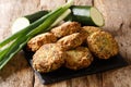 Mediterranean cuisine zucchini fritters with feta cheese close-up on a slate board. Horizontal Royalty Free Stock Photo