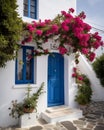 Captivating Greek House with White Walls, Blue Accents, and Blooming Pink Flowers