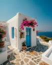 Captivating Greek House with White Walls, Blue Accents, and Blooming Pink Flowers