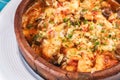 Seafood stew soup- shrimp, fish meat and mushrooms, with cheese and greens Royalty Free Stock Photo