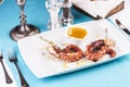 Mediterranean dish fried octopus tentacles with bolzimik sauce and rosemary Royalty Free Stock Photo