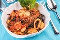 Black pasta with shrimps, crab meat, seafood, squid rings, basil, greens and cheese. Royalty Free Stock Photo