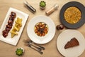 Mediterranean dishes, octopus stewed with potato cream, grilled boneless chicken wings, white bean stew and a portion of chocolate Royalty Free Stock Photo