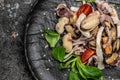 Mediterranean food, Seafood assorted platter octopus, mussels and shrimps on dark background. Food recipe background. Close up