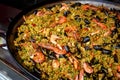 Seafood paella with rice, tomato sauce, langoustine, mussels, squid, shrimp. Royalty Free Stock Photo