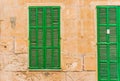 Mediterranean green wood window shutter and door with rustic stone wall Royalty Free Stock Photo