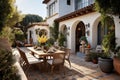 a mediterranean house with a tiled patio and outdoor dining setup