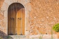 Mediterranean house with wooden front door and rustic stone wall Royalty Free Stock Photo